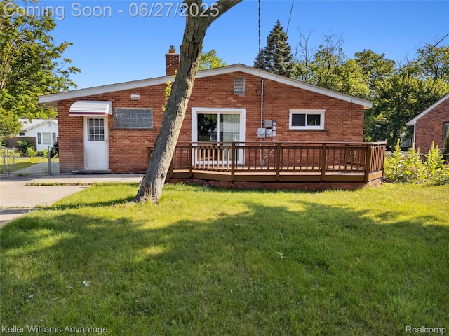 36669 Pinetree St, Livonia, MI 48150 - rear view of house with brick siding, a wooden deck, a lawn, and a chimney