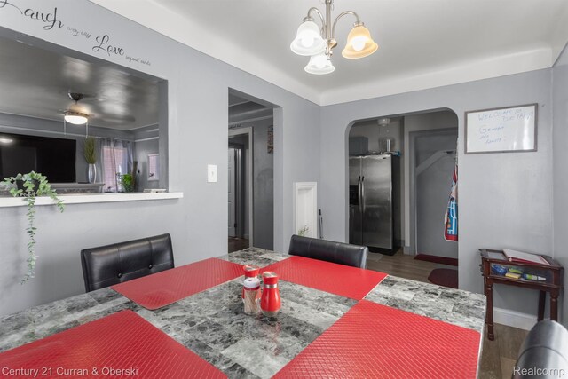 11670 Marlowe St, Detroit, MI 48227 - dining space with wood finished floors, a chandelier, and arched walkways