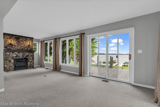 2222 Garland St, Sylvan Lake, MI 48320 - unfurnished living room featuring a water view, carpet, and a stone fireplace