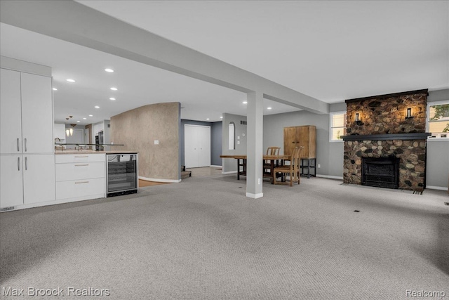 2222 Garland St, Sylvan Lake, MI 48320 - living area with beverage cooler, a fireplace, recessed lighting, and light carpet
