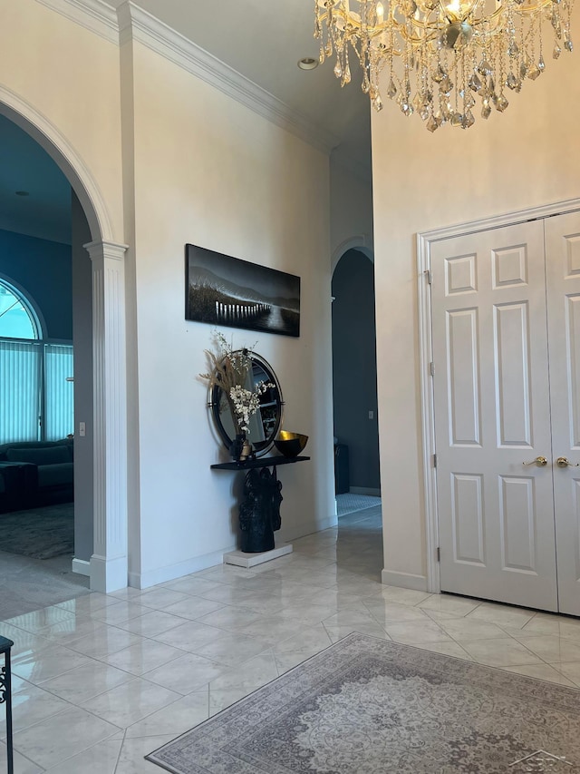 13 E Grove Ct, Freeland, MI 48623 - corridor with arched walkways, marble look tiles, a chandelier, crown molding, and a high ceiling
