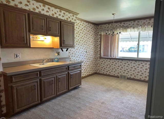 24739 Blackmar Ave, Warren, MI 48091 - kitchen featuring wallpapered walls, light colored carpet, light countertops, crown molding, and dark brown cabinetry