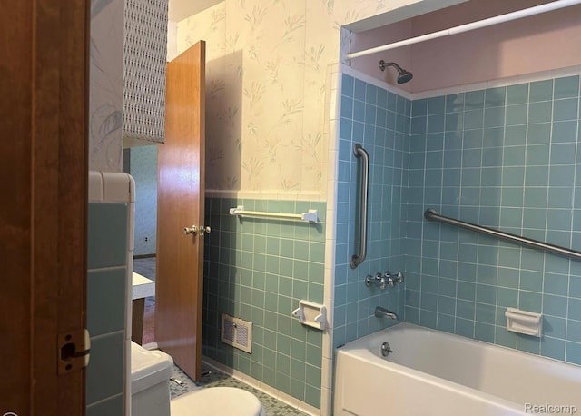 24739 Blackmar Ave, Warren, MI 48091 - bathroom with wallpapered walls, shower / tub combination, wainscoting, tile walls, and tile patterned flooring