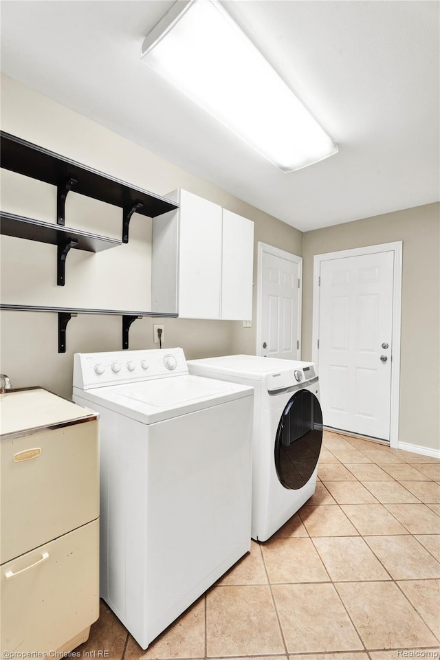 4770 Hedgewood Dr, Bloomfield Hills, MI 48301 - laundry room with separate washer and dryer, light tile patterned floors, and cabinet space