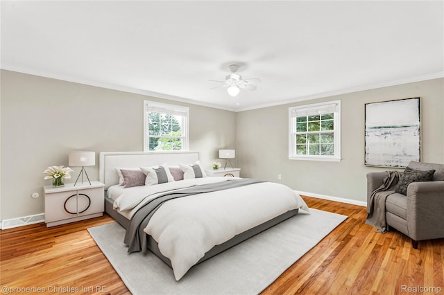 4770 Hedgewood Dr, Bloomfield Hills, MI 48301 - bedroom featuring multiple windows, crown molding, light wood finished floors, and a ceiling fan
