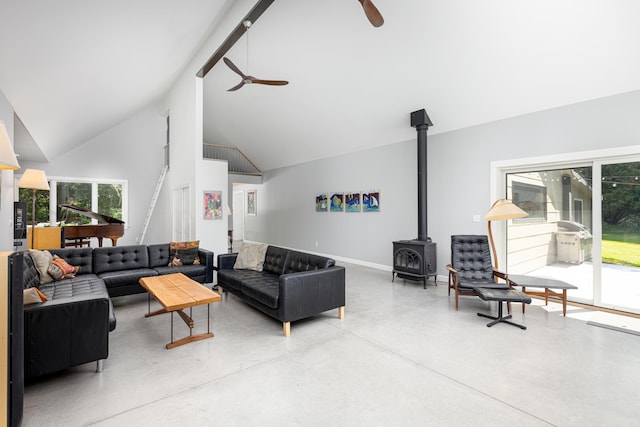2012 Pontiac Trl, Ann Arbor, MI 48105 - living area featuring a ceiling fan, a wood stove, concrete flooring, and high vaulted ceiling