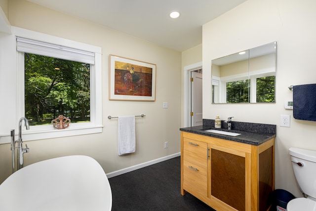 2012 Pontiac Trl, Ann Arbor, MI 48105 - full bathroom featuring vanity, a freestanding tub, and recessed lighting