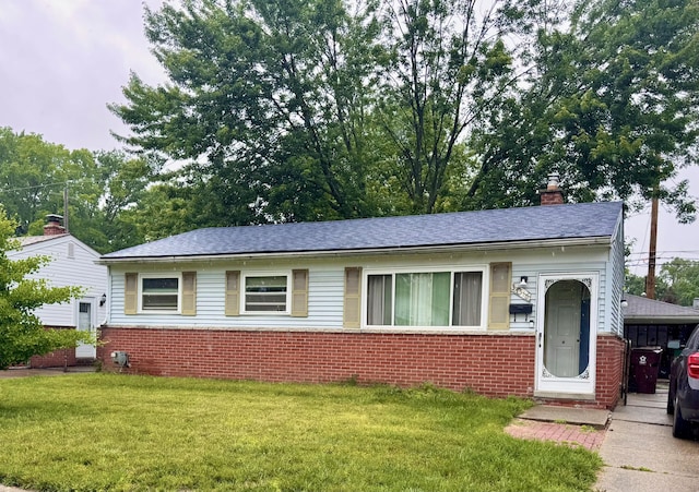 34516 John St, Wayne, MI 48184 - view of front of property featuring brick siding, a front yard, and a chimney