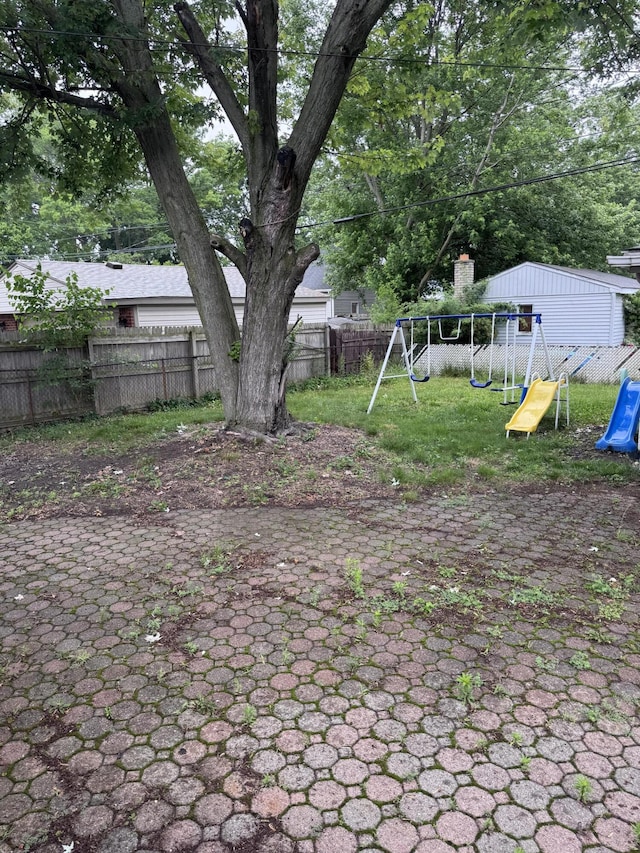 34516 John St, Wayne, MI 48184 - fenced backyard featuring a playground