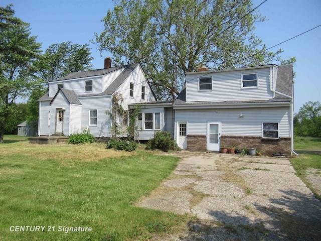 7300 Corunna Rd, Swartz Creek, MI 48473 - rear view of property with a yard, a chimney, and brick siding