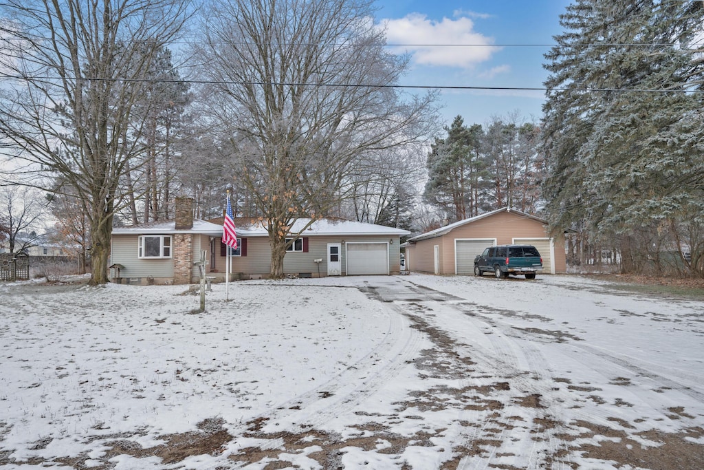 1007 N Main St, Evart, MI 49631 - ranch-style home featuring a chimney and a detached garage
