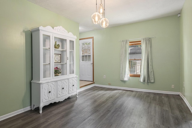 109 N Lincoln Ave, Niles, MI 49120 - unfurnished dining area featuring dark wood-style floors and baseboards