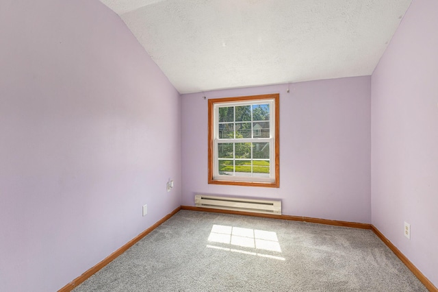 109 N Lincoln Ave, Niles, MI 49120 - carpeted empty room with a baseboard radiator, vaulted ceiling, and a textured ceiling