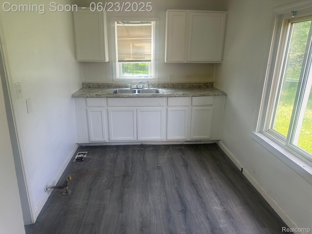 4080 Isabelle St, Dearborn, MI 48141 - kitchen with dark wood-type flooring, white cabinetry, and light countertops