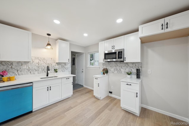 11020 Jewett Ave, Warren, MI 48089 - kitchen with dishwasher, stainless steel microwave, tasteful backsplash, white cabinets, and light wood-type flooring