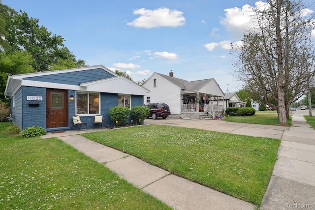 11020 Jewett Ave, Warren, MI 48089 - bungalow-style home featuring covered porch, a front yard, brick siding, and concrete driveway
