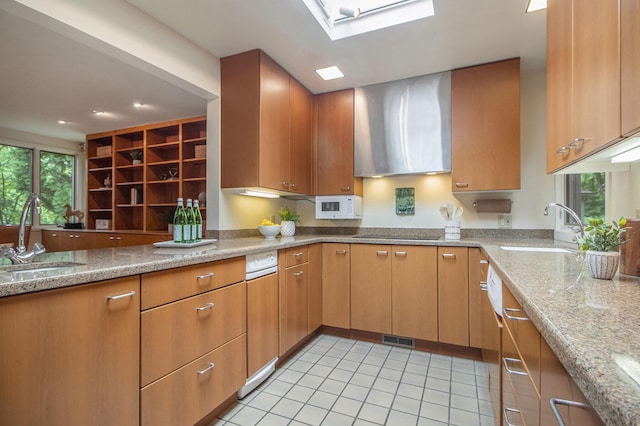 13 Regent Dr, Ann Arbor, MI 48104 - kitchen featuring light tile patterned floors, light stone countertops, black electric cooktop, wall chimney range hood, and recessed lighting