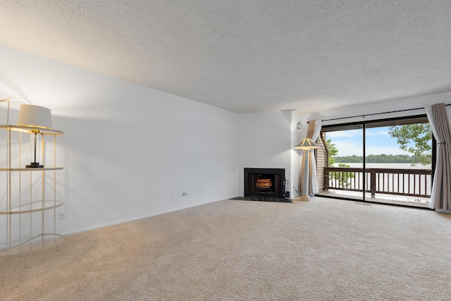 730 Cliffs Dr Unit 304A, Ypsilanti, MI 48198 - unfurnished living room with carpet, a textured ceiling, a fireplace with flush hearth, and a water view