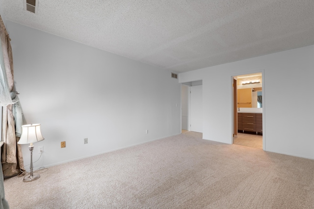 730 Cliffs Dr Unit 304A, Ypsilanti, MI 48198 - unfurnished bedroom featuring light carpet, a textured ceiling, and ensuite bathroom