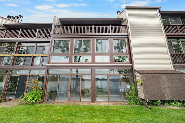 730 Cliffs Dr Unit 304A, Ypsilanti, MI 48198 - rear view of property featuring a shed, a balcony, and a yard