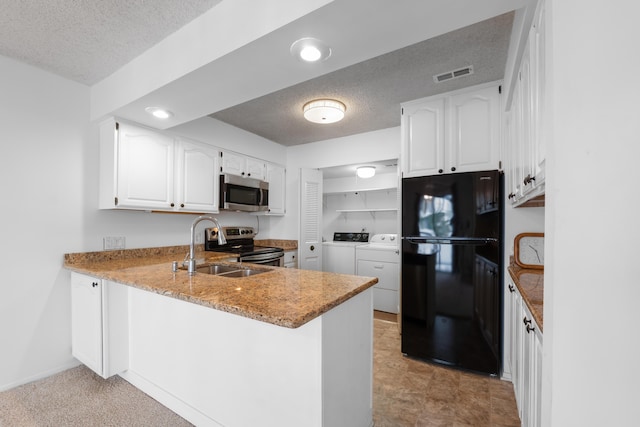 730 Cliffs Dr Unit 304A, Ypsilanti, MI 48198 - kitchen featuring stainless steel appliances, washing machine and clothes dryer, a peninsula, a textured ceiling, and white cabinetry