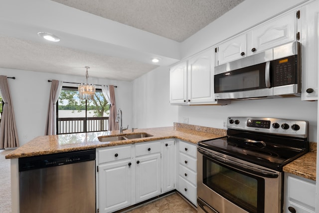 730 Cliffs Dr Unit 304A, Ypsilanti, MI 48198 - kitchen with stainless steel appliances, a textured ceiling, a peninsula, a chandelier, and white cabinetry