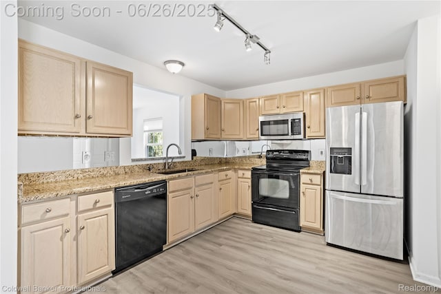 880 Seville Row, Detroit, MI 48202 - kitchen with black appliances, light brown cabinetry, rail lighting, and light wood-style floors