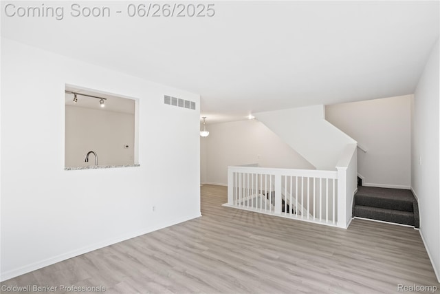 880 Seville Row, Detroit, MI 48202 - empty room featuring wood finished floors and track lighting