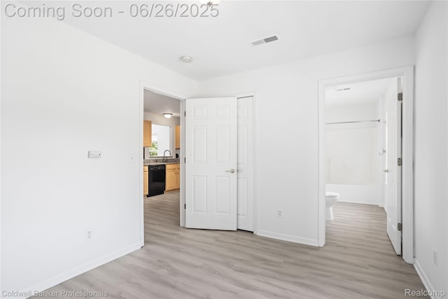 880 Seville Row, Detroit, MI 48202 - unfurnished bedroom featuring light wood-style floors, a closet, and connected bathroom