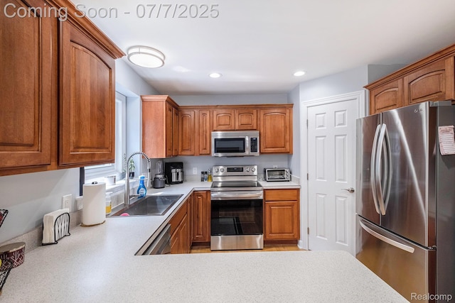 2390 Torrey Grove Ct, Fenton, MI 48430 - kitchen with appliances with stainless steel finishes, light countertops, brown cabinetry, and recessed lighting