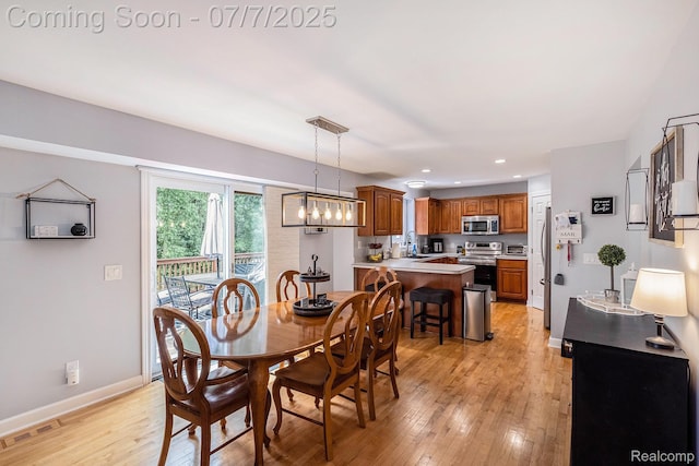 2390 Torrey Grove Ct, Fenton, MI 48430 - dining room featuring light wood-type flooring, recessed lighting, and a chandelier