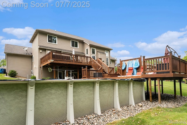 2390 Torrey Grove Ct, Fenton, MI 48430 - rear view of property with a wooden deck and a covered pool