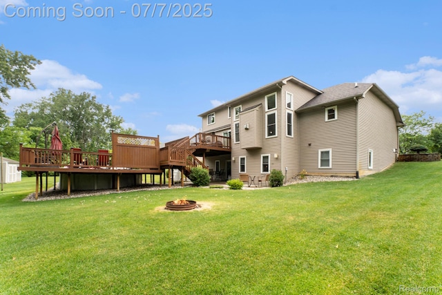 2390 Torrey Grove Ct, Fenton, MI 48430 - back of house with an outdoor fire pit, a deck, stairway, a lawn, and a patio