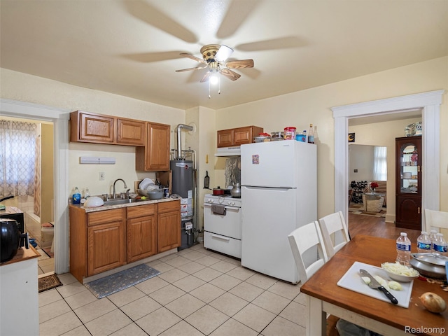 11727 Fleming St, Hamtramck, MI 48212 - kitchen featuring white appliances, a ceiling fan, light countertops, brown cabinetry, and gas water heater