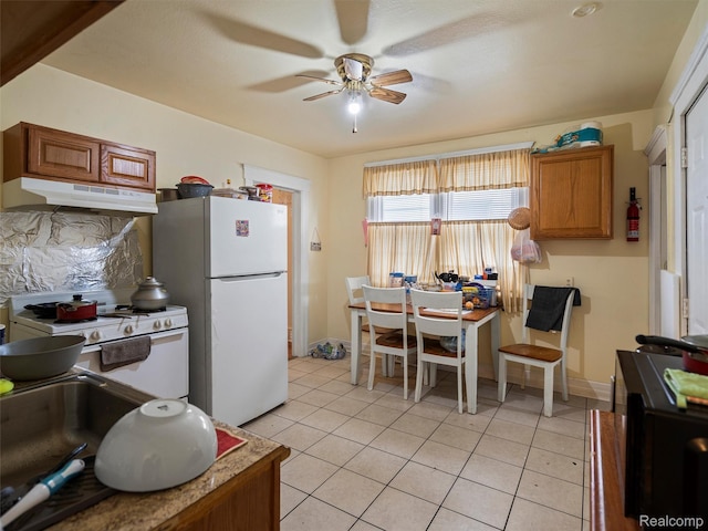 11727 Fleming St, Hamtramck, MI 48212 - kitchen featuring under cabinet range hood, white appliances, a ceiling fan, light tile patterned flooring, and brown cabinets