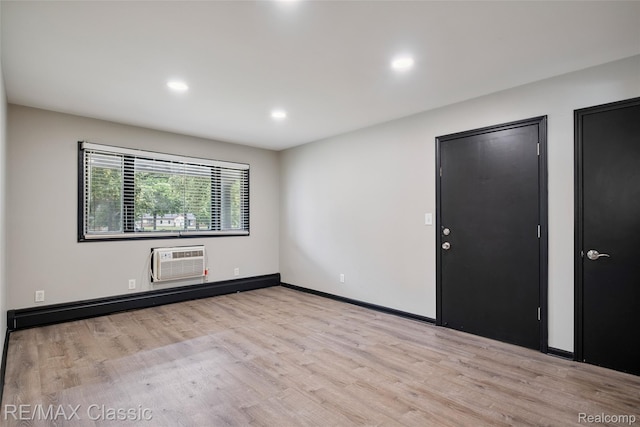 3241MARSHALLAVENUE 3241 Marshall Ave SE, Kentwood, MI 49508 - spare room featuring a wall mounted air conditioner, wood finished floors, recessed lighting, and a baseboard radiator