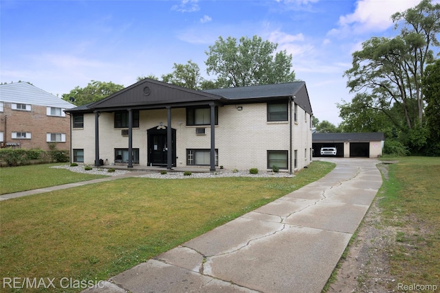 3241MARSHALLAVENUE 3241 Marshall Ave SE, Kentwood, MI 49508 - split foyer home with a front yard, a garage, brick siding, and an outdoor structure