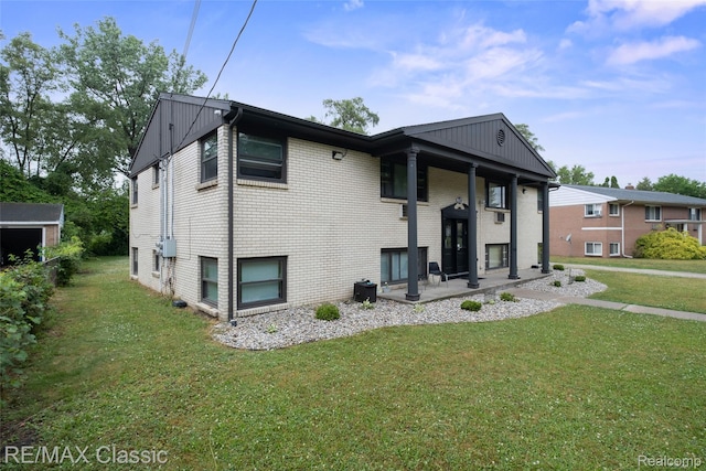 3241MARSHALLAVENUE 3241 Marshall Ave SE, Kentwood, MI 49508 - back of house with a yard and brick siding
