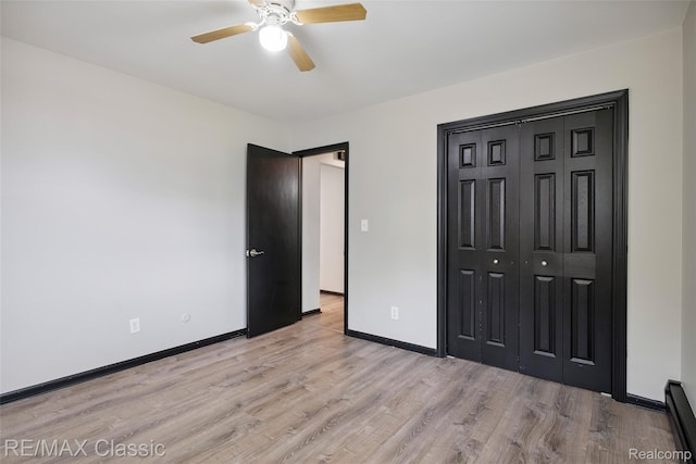3241MARSHALLAVENUE 3241 Marshall Ave SE, Kentwood, MI 49508 - unfurnished bedroom with light wood-style flooring, a closet, and a ceiling fan