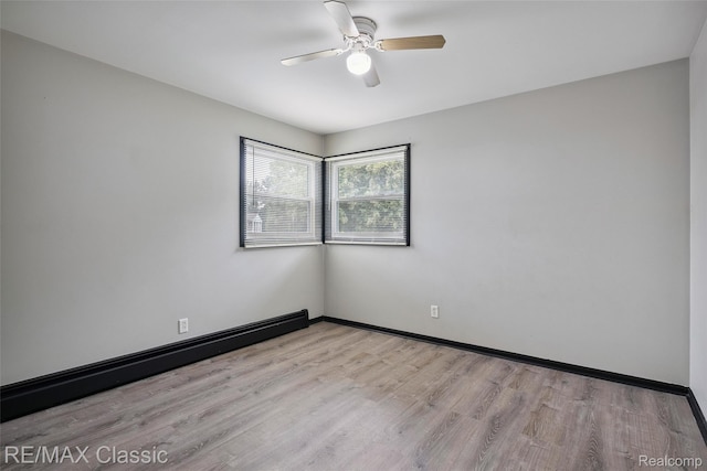 3241MARSHALLAVENUE 3241 Marshall Ave SE, Kentwood, MI 49508 - unfurnished room with ceiling fan, wood finished floors, and a baseboard heating unit