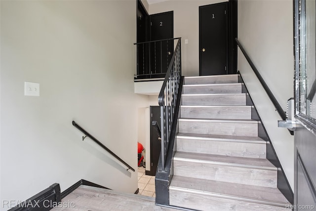 3241MARSHALLAVENUE 3241 Marshall Ave SE, Kentwood, MI 49508 - staircase featuring tile patterned floors