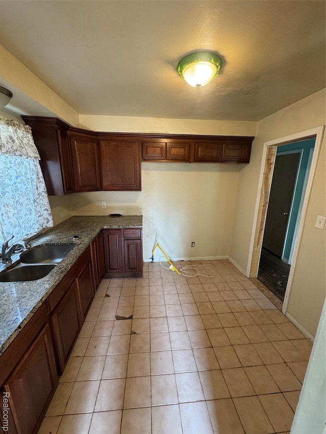 19421 Huntington Rd, Detroit, MI 48219 - kitchen featuring light tile patterned floors and stone countertops