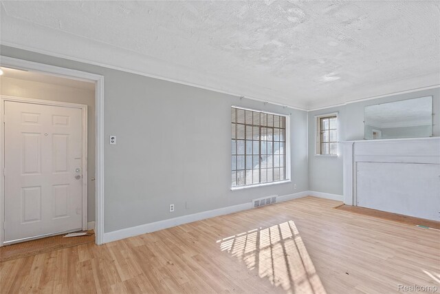14903 Tracey St, Detroit, MI 48227 - empty room featuring a textured ceiling, wood finished floors, and ornamental molding