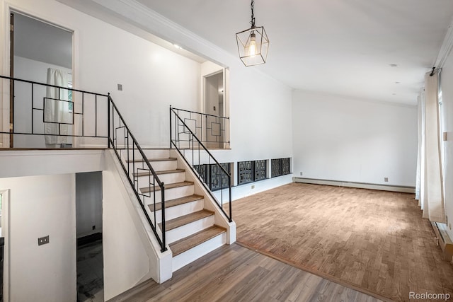 720 E Grand Blanc Rd, Grand Blanc, MI 48439 - stairway with wood finished floors, a baseboard radiator, and crown molding
