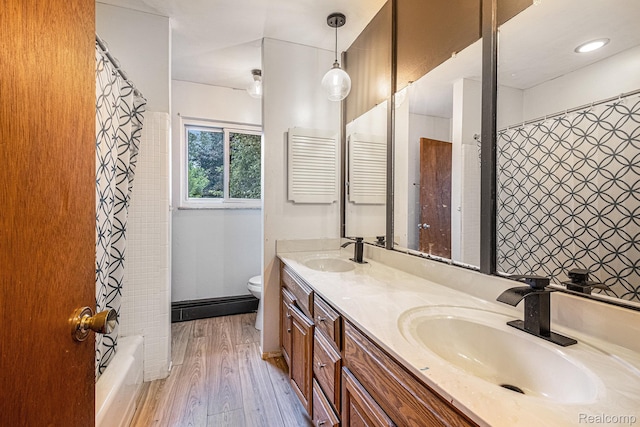 720 E Grand Blanc Rd, Grand Blanc, MI 48439 - bathroom featuring double vanity, wood finished floors, and shower / bath combination with curtain