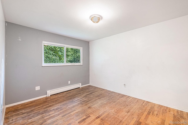 720 E Grand Blanc Rd, Grand Blanc, MI 48439 - empty room featuring a baseboard radiator and light wood-type flooring