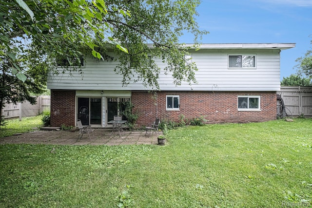 720 E Grand Blanc Rd, Grand Blanc, MI 48439 - back of house featuring a fenced backyard, brick siding, and a patio area