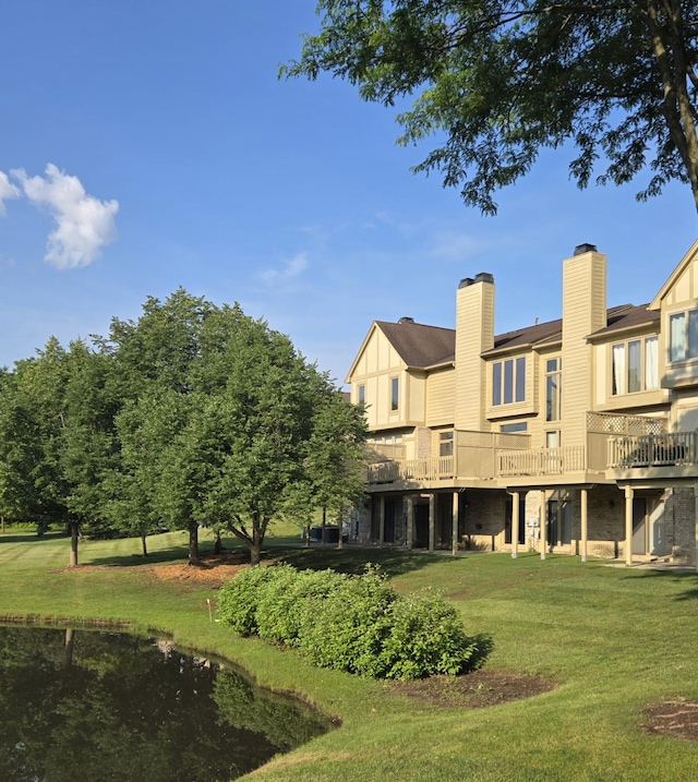 2782 Maitland Dr, Ann Arbor, MI 48105 - rear view of house featuring a lawn, a chimney, and a deck