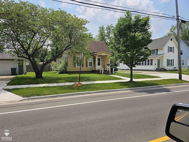 209 W Stewart St, Owosso, MI 48867 - obstructed view of property featuring a front yard and driveway