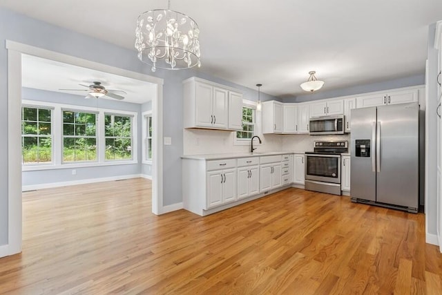450 Carefree Ct, Niles, MI 49120 - kitchen with appliances with stainless steel finishes, light wood-type flooring, a ceiling fan, and light countertops